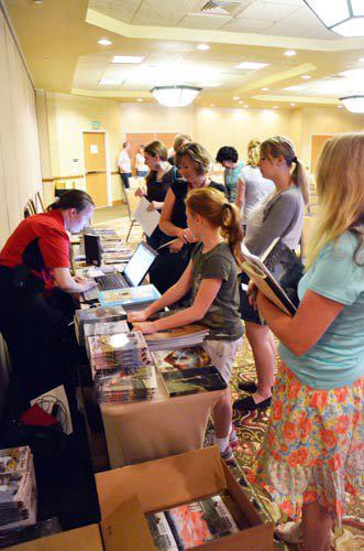 Emmaline Hoffmeister is selling books at the Rhemalda Publishing Got Stories Conference in Salt Lake City, Utah.