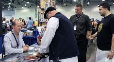 Rhett and two readers signing books with author Douglas Brown at the 2012 Columbus, Ohio Comic Con