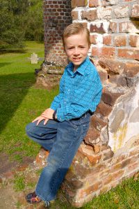 DEH posing against a brick wall at the Old Sheldon Church.