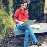 Emmaline Hoffmeister sitting with her laptop in Idaho.