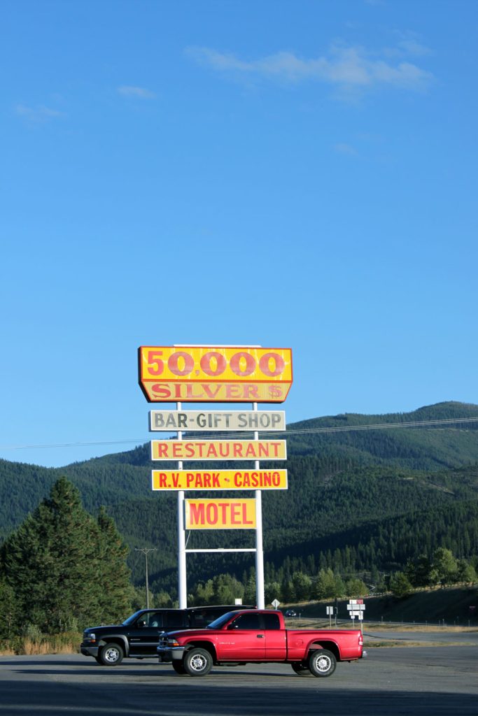 Road sign at the 50,000 Silver Dollar Bar, Haugan Montana