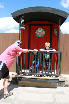 Rhett and the boys posing with the train caboose at Wall Drug in South Dakota.