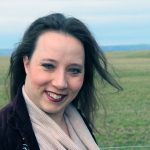 Emmaline Hoffmeister standing in front of the Eastern Washington farmlands.