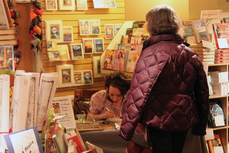 Author Emmaline Hoffmeister signing books for reader Anne Lavigne at Queen Anne Book Company in Seattle, Washington.