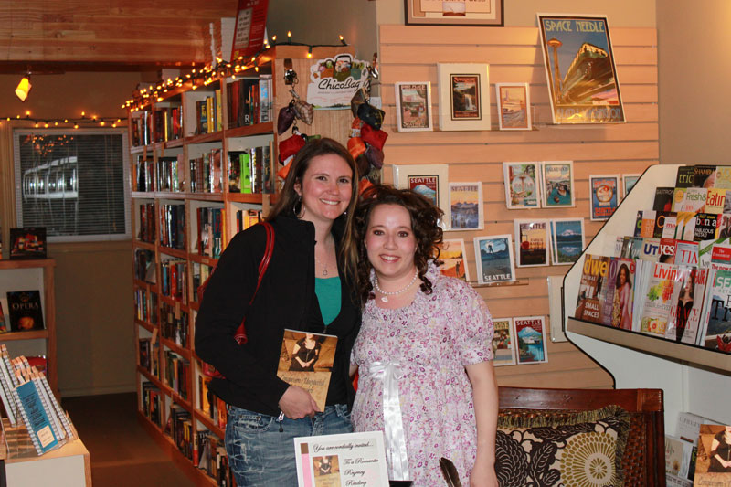 Author Emmaline Hoffmeister signing books for reader Genvieve O'Sullivan at Queen Anne Book Company in Seattle, Washington.