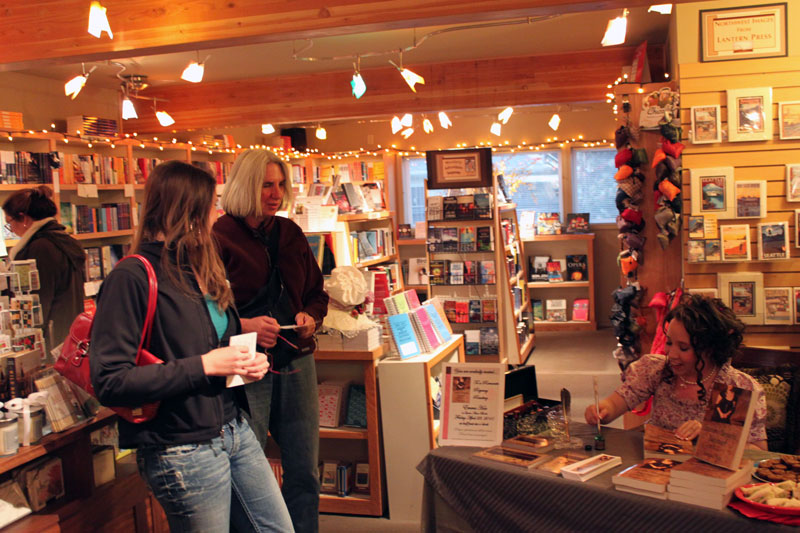 Author Emmaline Hoffmeister signing books for readers at Queen Anne Book Company in Seattle, Washington.