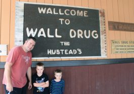 Rhett with ARH and DEH in front of the sign at Wall Drug in South Dakota.