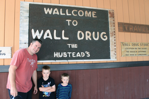 Rhett with ARH and DEH in front of the sign at Wall Drug in South Dakota.