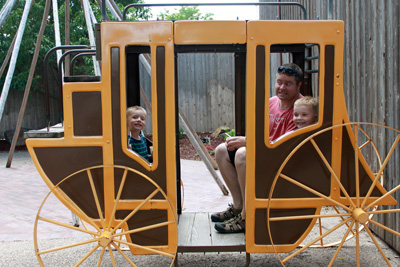 Rhett with ARH and DEH in the stagecoach at Wall Drug in South Dakota.