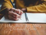 A close-up of a person writing in a devotional journal with a pen, wearing a gold ring and mustard-colored sweater, symbolizing reflection and daily scripture study.